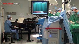 Boy has surgery as piano played next to operating table