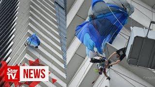 Putrajaya Base Jump participant gets stuck at side of building, brought down safely