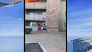 Watch: Man makes life-saving catch as mother throws young son from burning balcony in Arizona.