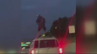 VIDEO: Joyriding man chained to top of SUV in viral Detroit freeway clip