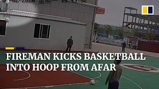 Chinese fireman kicks basketball from outside the court into hoop