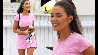 Olivia Culpo flaunts her rock-hard abs and underboob in a pink crop top and matching mini skirt for