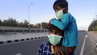 This father is carrying his 5 year old child on his back and walking hundreds of kilometres