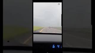 BAD DAD drives convertible BMW into rain storm with top down and kids in the car.