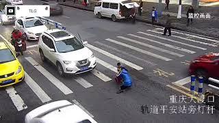 Furious child kicks out at car that knocked over his mother at zebra crossing in China